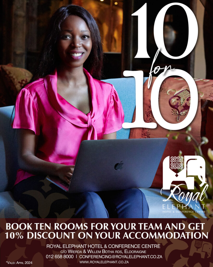 an Ad for Business Accommodation bulk rates. A young black woman sitting in the Royal Lounge of the Royal Elephant Hotel with an open apple laptop on her lap